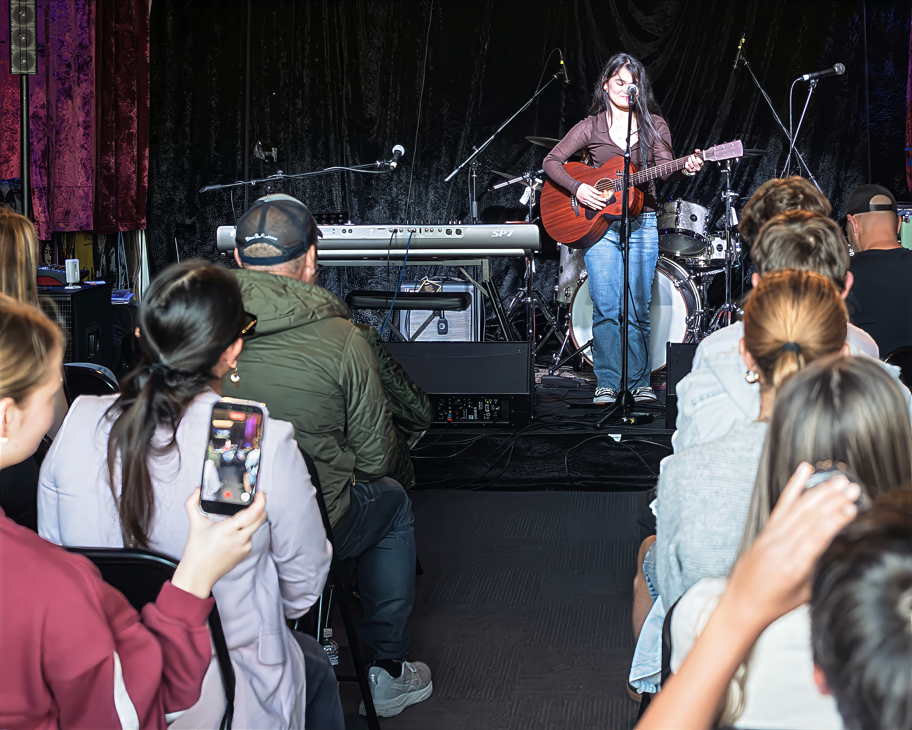 Alexa performing for audience at Youth Open Mic